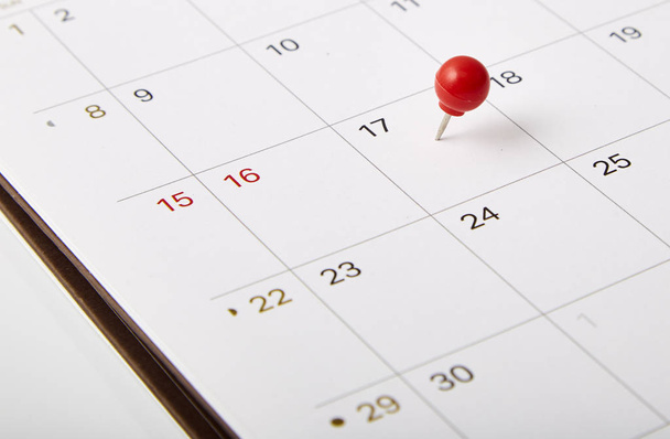 Red thumbtack a date 17th on calendar or planner. Tax Day 2018 takes place on April 17. selective focus - Photo, Image