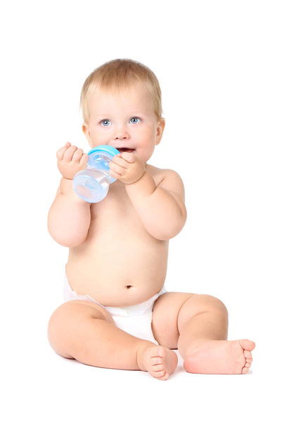 Baby boy drinking water from bottle isolated on white background - Fotó, kép