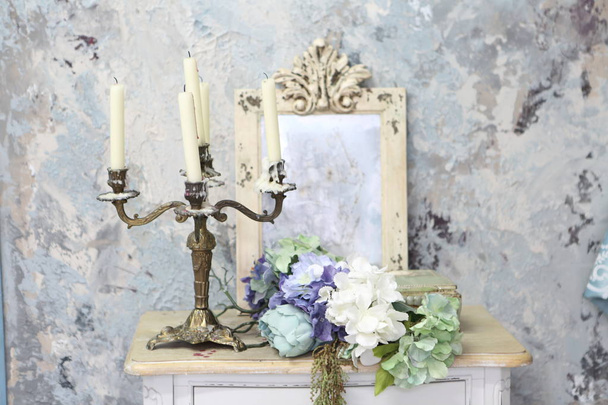 Antique candlestick on vintage table - Foto, afbeelding