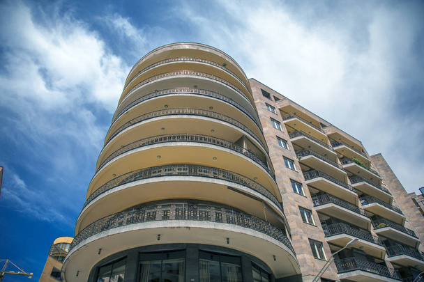 beautiful high building with balconies  in street - Fotó, kép
