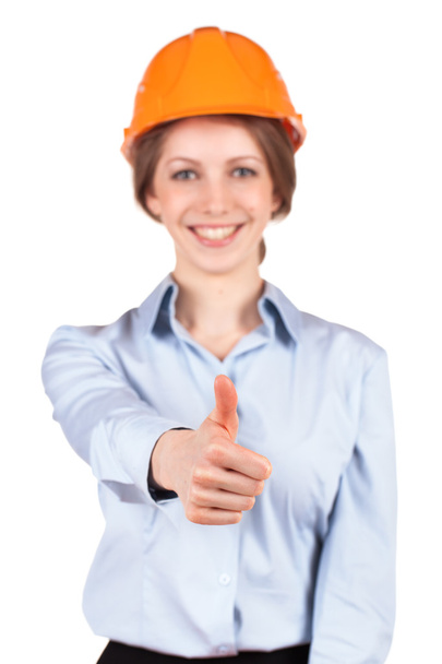 Girl in a protective helmet shows that all okay - Foto, imagen