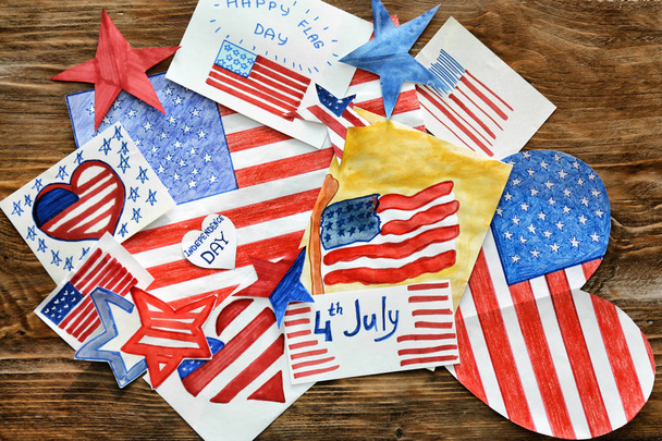 Many paintings of American national flag on wooden table. 4th July celebration - Photo, Image