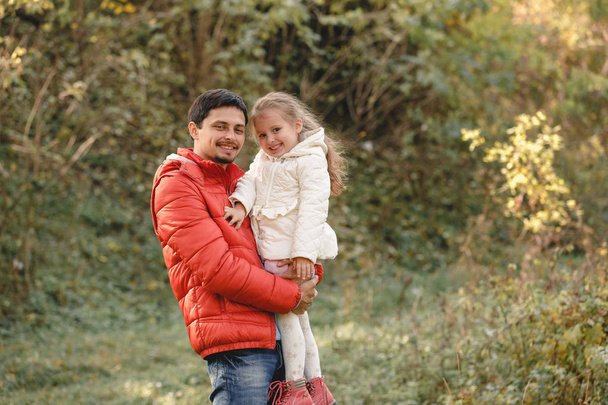 father walks with little daughter girl and smiles happily - Foto, afbeelding