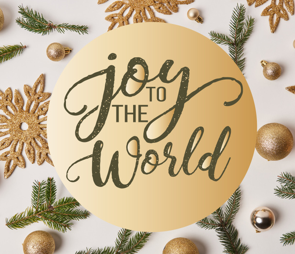 top view of golden Christmas decoration on white with "joy to the world" inspiration - Photo, Image