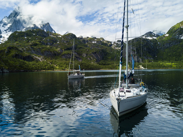 Yachting in the Troll Fjord on the background of snowy mountains - Фото, зображення