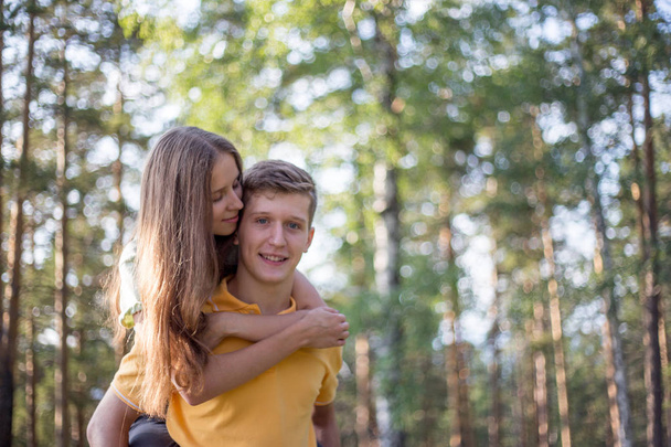 young couple in love walking in the forest together - 写真・画像