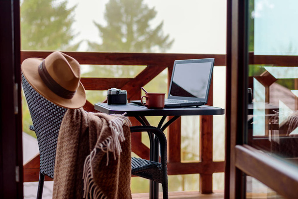 Laptop or notebook, camera, cup on the table. Concept of freelance or remote business, bloger, writer. - Foto, Imagem