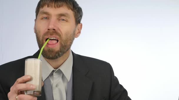 bearded businessman drinks healthy milk cocktail. cocktail from vegetable and fruit. slow motion - Filmmaterial, Video
