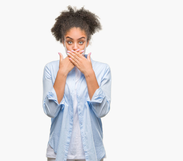 Young afro american woman over isolated background shocked covering mouth with hands for mistake. Secret concept. - Photo, image