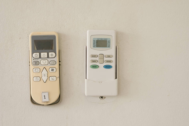 Air conditioner remote control on white wall - Photo, Image