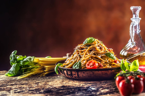 Italian pasta spaghetti with tomato sauce olive oil basil and parmesan cheese in old pan. - Φωτογραφία, εικόνα