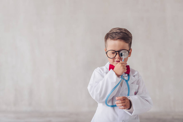 Little doctor with a stethoscope indoors - Photo, image