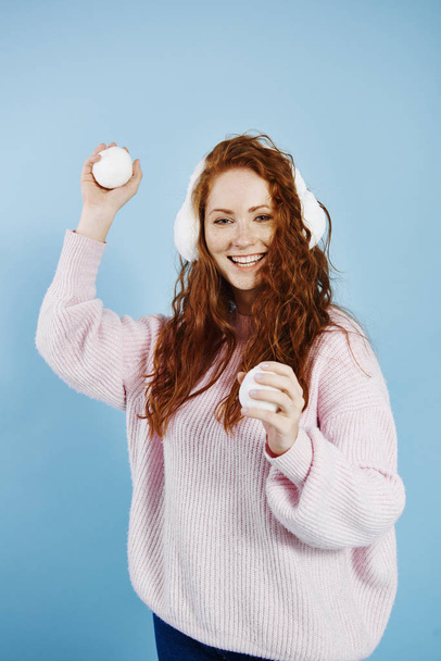 Portrait of happy girl throwing snowball - Foto, Imagen