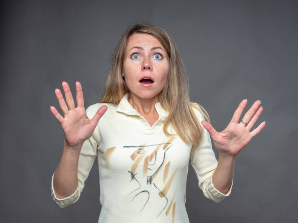Emotional woman. Shocked and surprised adult girl overwhelmed with emotions. Expressive facial expressions and real feelings. Portrait of european woman isolated on gray background. - Foto, Bild