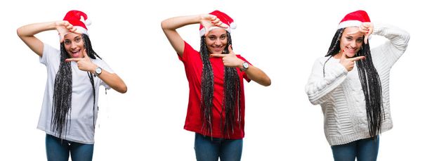 笑顔の幸せそうな顔で指と手作りフレーム分離の背景にクリスマスの帽子を着て美しいアフリカ系アメリカ人女性のコラージュ。創造性と写真のコンセプト. - 写真・画像