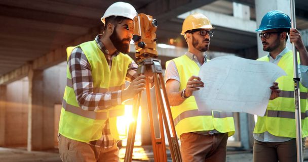 Portrait of construction engineers working on building site together - Foto, Imagem