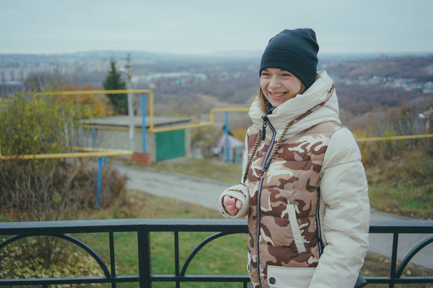 Girl posing on the street, a student in street clothes in the winter. street style. emotional portraits - Zdjęcie, obraz