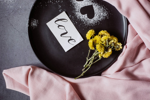Valentines day.  Scarf, flower and heart on gray table from above in flat lay style. - Foto, immagini