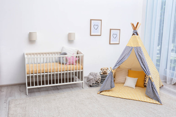 Cozy baby room interior with play tent and toys - Photo, Image
