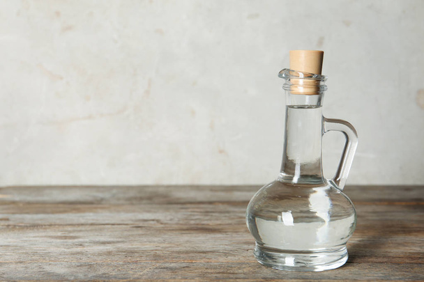 Glass jug with vinegar on table. Space for text - Zdjęcie, obraz