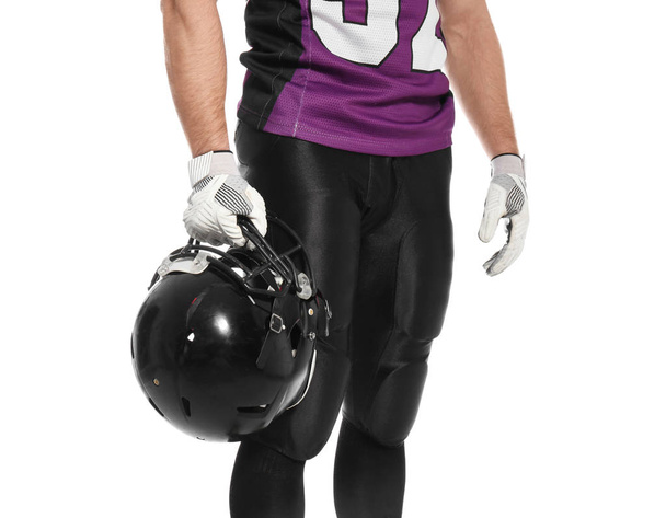 American football player with helmet wearing uniform on white background, closeup - 写真・画像