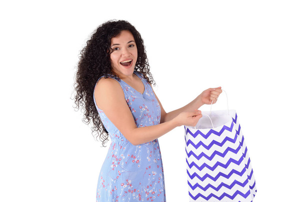 Young beautiful woman holding shopping bags. Isolated white background. - Fotó, kép