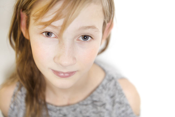 cute cheerful little girl portrait, isolated on grey background red head - 写真・画像