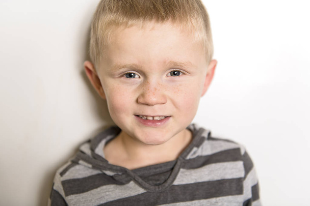 portrait of a 5-year old child on grey background studio - Foto, Imagem