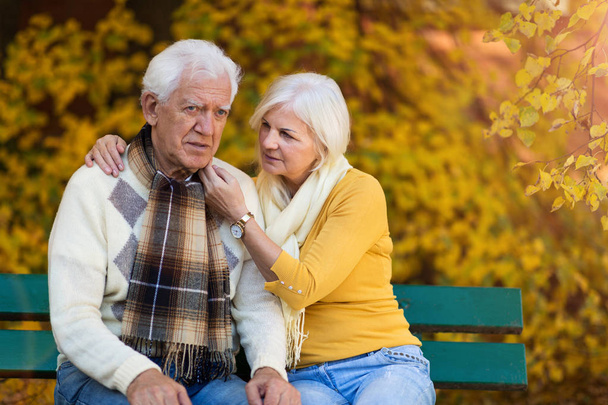 Depressed senior man consoled by elderly woman - Valokuva, kuva
