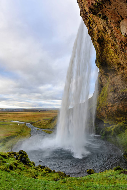 Majestic Seljalandsfoss; the most famous waterfall in Iceland. Sunset landscape. Beautiful tourist attraction in one of the main holiday destinations. - Photo, Image