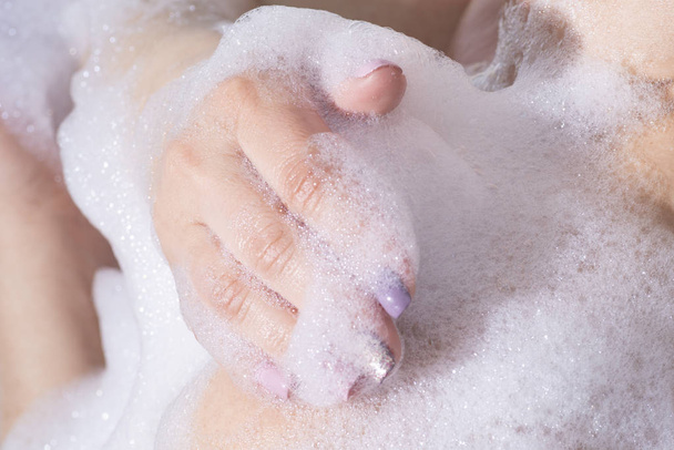Girl washing in the bathroom with foam - 写真・画像