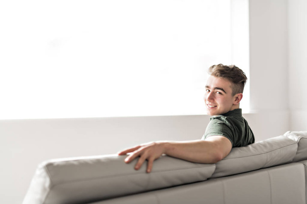 Handsome confident young man relaxing at home on the sofa - Φωτογραφία, εικόνα