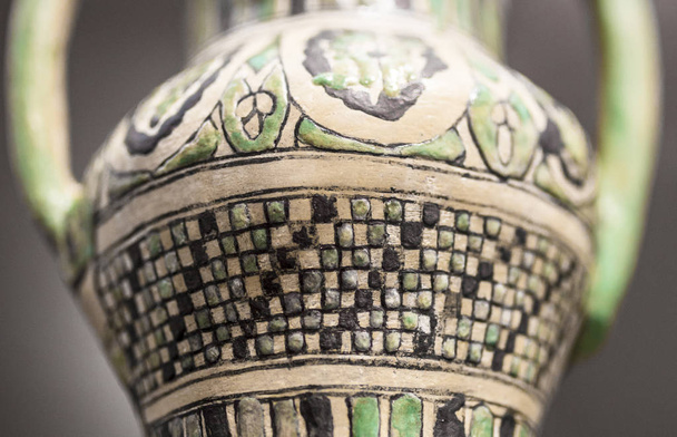 Malaga, Spain - Sept 21th, 2018: Moorish small jar with partial cuerda seca decoration. Nasrid dynasty. Malaga Museum, Spain. Detail - Fotoğraf, Görsel