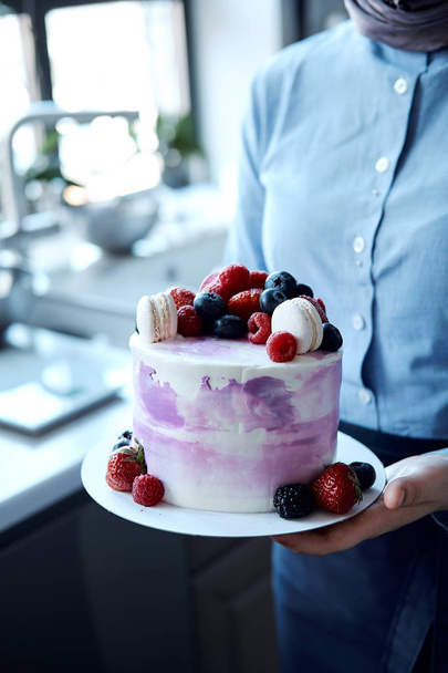 Holiday cake. Sweet desserts with berries and macarons. Cake from the fruit. Delicious sponge cake - Foto, Imagen