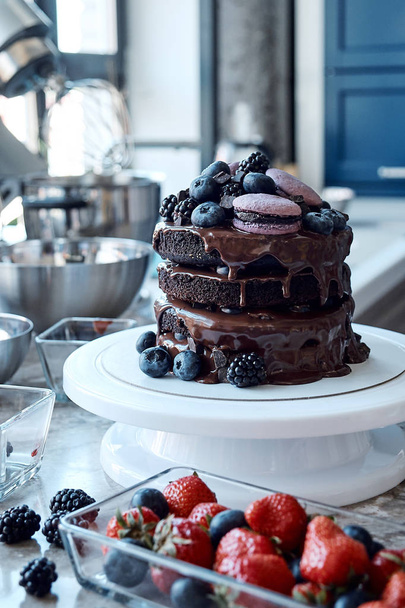 Fresh delicious homemade chocolate cake with berries and macaroni. - Фото, зображення