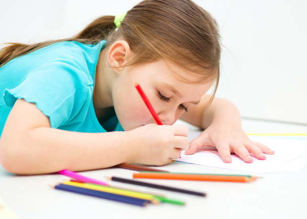 Little girl is drawing using pencils - Foto, Imagen