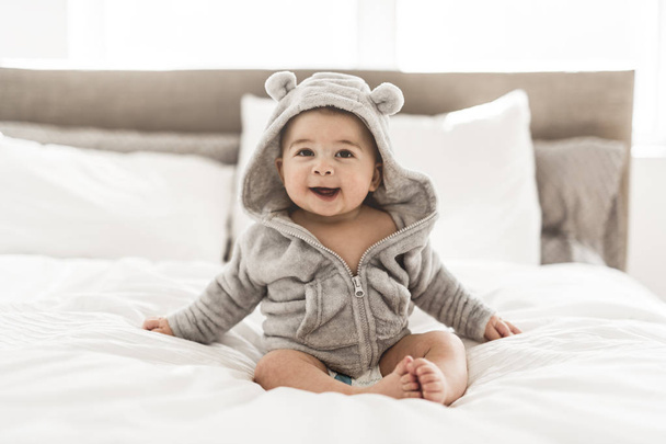 Portrait of a baby boy on the bed in bedroom - Foto, immagini