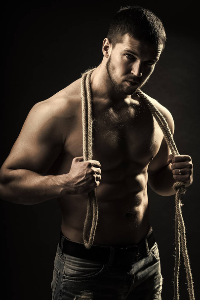 Muscular man with rope - Zdjęcie, obraz