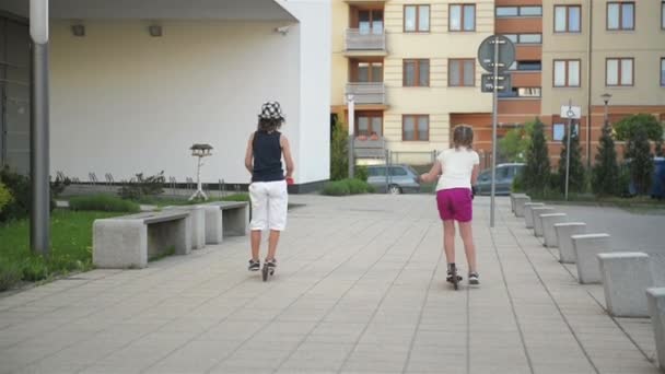 Children Learn To Ride Scooter On Sunny Summer Day. Kids Play Outdoors With Scooters. Active Leisure and Outdoor Sport For Child. - Felvétel, videó
