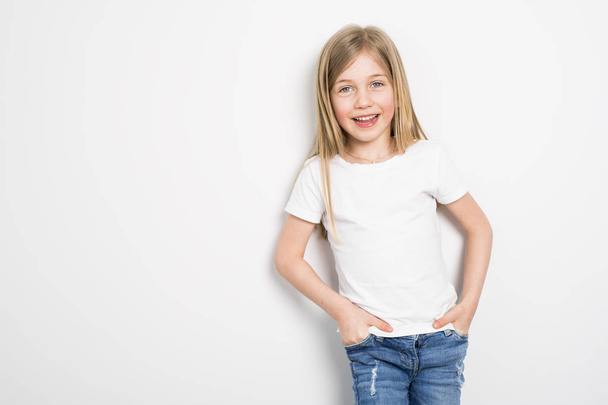 Happy small five years old girl with straight hair over white background at home - Foto, Imagem