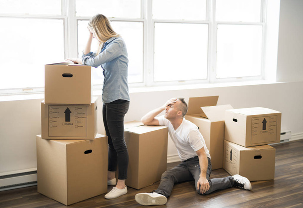 A tired woman with box at home moving from - Photo, image