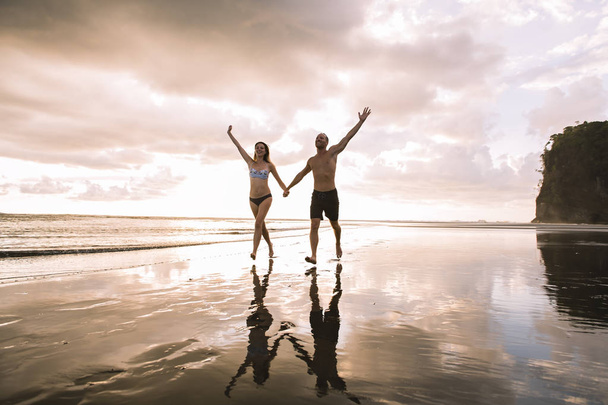 Pár v lásce má nabídka romantické chvíle při západu slunce na pláži - Fotografie, Obrázek