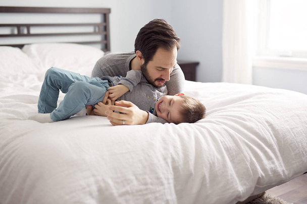 Father and son in bed, happy time on bed - Φωτογραφία, εικόνα