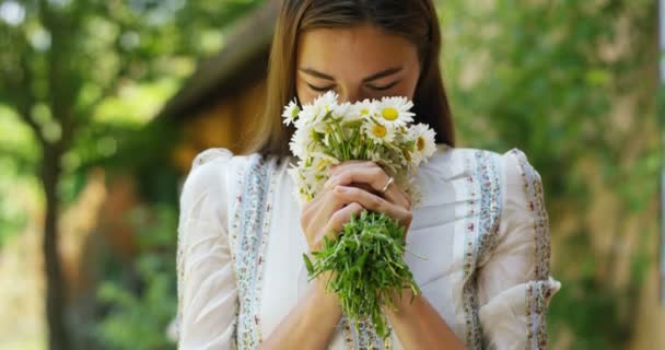 video of woman smelling white daisies flowers bouquet  - Imágenes, Vídeo