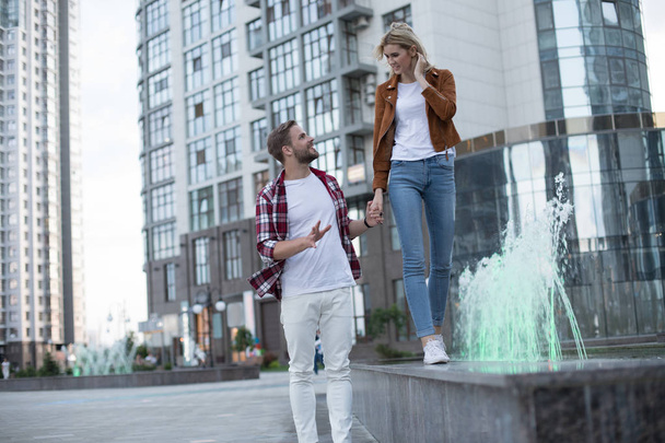 Cheerful interested couple is walking down outside - Fotografie, Obrázek
