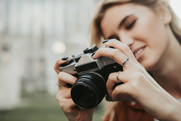 Close up of camera in hands of young woman - Fotografie, Obrázek