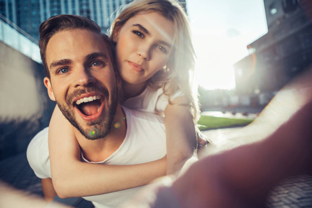 Happy smiling man and woman making selfie - Фото, изображение
