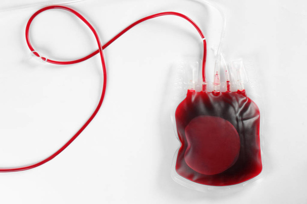 Blood pack for transfusion on white background, top view. Donation day - 写真・画像