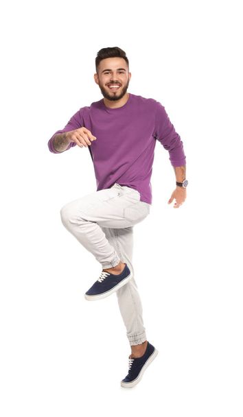Handsome young man jumping on white background - Foto, afbeelding
