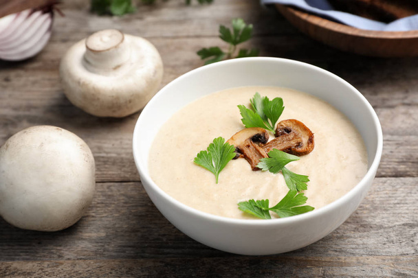 Bowl of fresh homemade mushroom soup on wooden table - Photo, image
